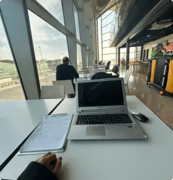 Letket team member coding in a cozy coffeeshop.
